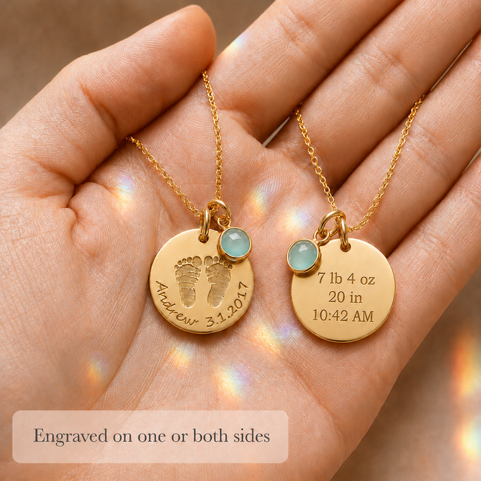 Personalized baby footprint necklace held in hand, showing front and back engraving options for name, date, birth weight, length, and time.