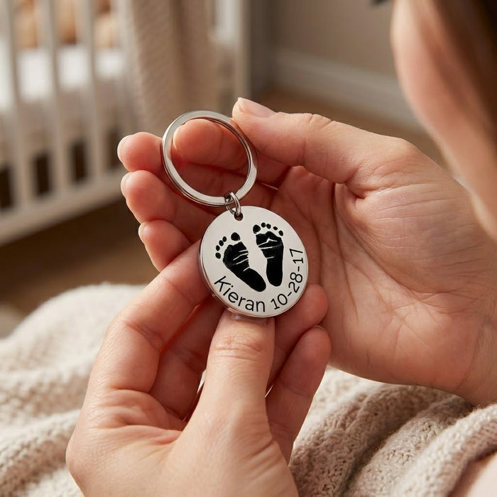Close-up of a personalized baby footprint keychain engraved from an actual baby footprint photo, featuring crisp detailing and smooth stainless steel finish. This custom baby footprint keepsake includes optional name and date engraving, making it a heartfelt new mom gift, baby memorial keychain, or meaningful grandma gift. Designed as a lasting reminder of a child’s earliest days and milestones.