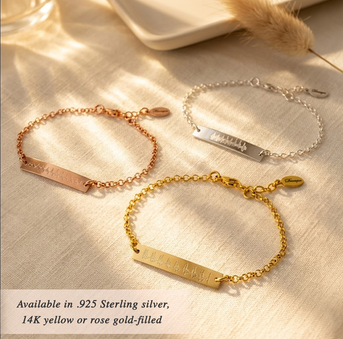 3 ultrasound bracelets in silver, rose gold and gold lay against a white background. What better gift for a new mom than her babys first heartbeat forever preserved in an elegantly simple bracelet? Perfect for her first Mothers Day!