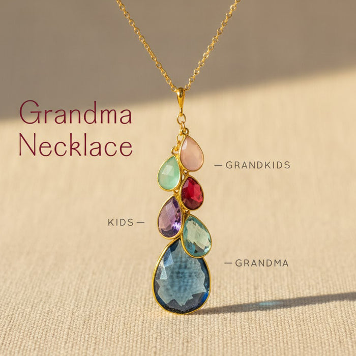 Grandma necklace with teardrop birthstones labeled for grandma, kids, and grandkids, showing how additional charms can build a family necklace.