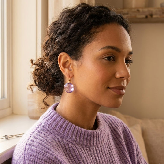 Woman wearing alexandrite quartz earrings in a soft lavender sweater for a June birthstone gift or everyday look