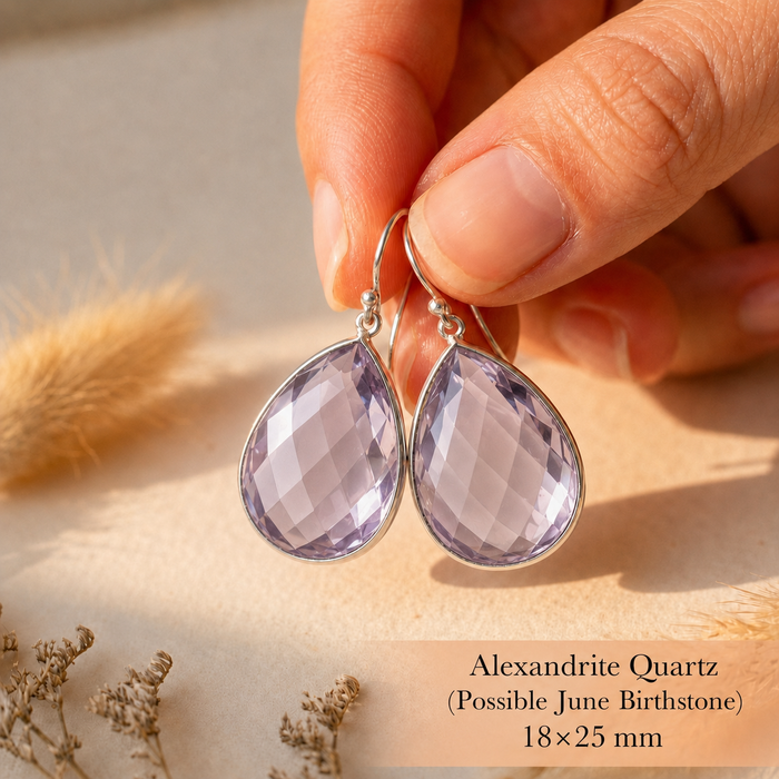 Close up of alexandrite quartz teardrop earrings showing transparent lavender faceted stones and gold earwires