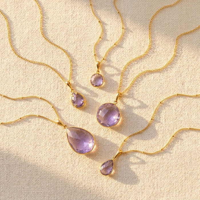 Alexandrite June birthstone necklaces in multiple pendant sizes with soft purple gemstones on gold chains.