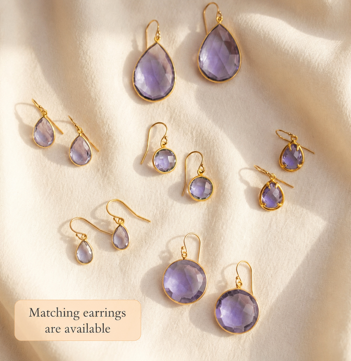 Matching alexandrite earrings and necklace pieces in soft purple gemstone styles.