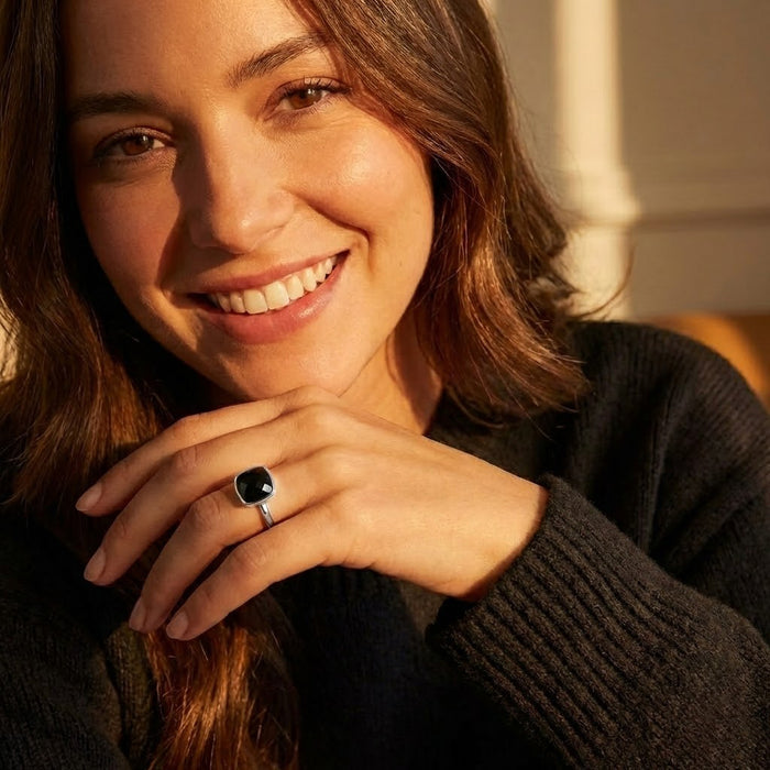 Faceted black onyx statement ring with cushion cut gemstone in smooth bezel setting, bold minimalist gold ring for women, modern cocktail ring style, handcrafted fine jewelry by Danique Jewelry