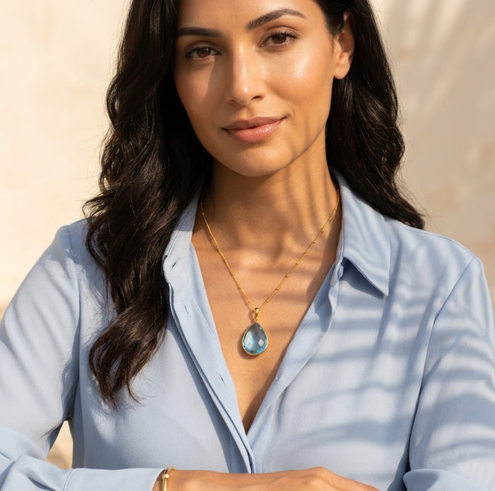 Blue topaz necklace on model in gold, sparkling December birthstone pendant, elegant gift for her