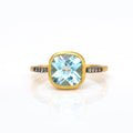 Gold plated blue topaz with white topaz pave setting ring on white background. December gemstone, december birthstone, december birthday. Bezel setting on white background