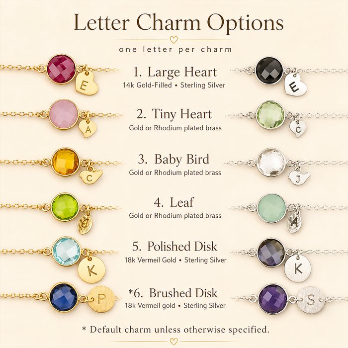 Letter charm options chart showing initial disc, heart, baby bird, leaf, brushed disc, and shield disc charms for personalized jewelry