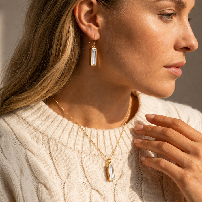 Model wearing clear quartz bar earrings and matching clear quartz necklace from the Adira Collection.