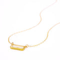 Single gold filled cable chain with horizontal clear quartz birthstone and secret message engraved on bottom of bar in script font