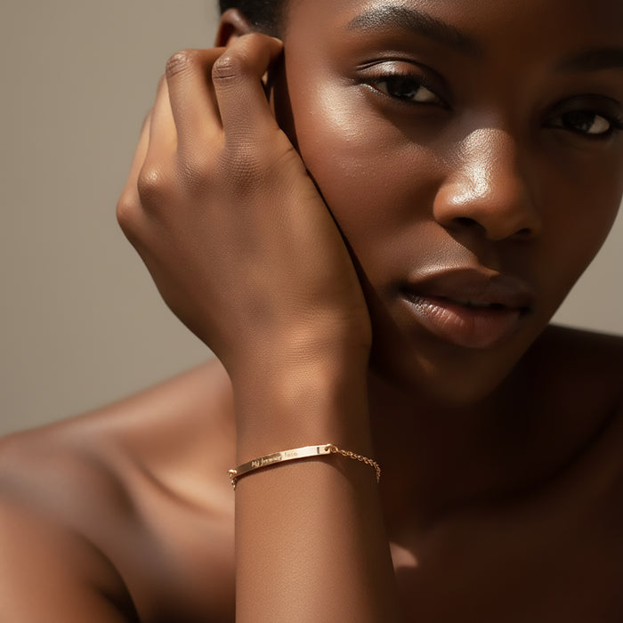 Lifestyle portrait of woman wearing a custom coordinates bar bracelet, engraved skinny bar bracelet in gold filled finish, minimalist personalized bracelet designed for everyday wear, latitude and longitude bracelet symbolizing a meaningful place, elegant dainty bar bracelet layered with natural light, personalized jewelry gift for her, anniversary or memorial coordinates bracelet, handcrafted bar bracelet with subtle engraving