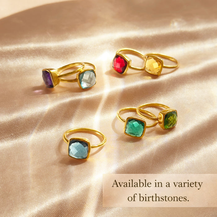 Collection of cushion cut gemstone rings including green onyx and other birthstones. This minimalist bezel set ring is available in a variety of birthstone options for personalized jewelry gifting.