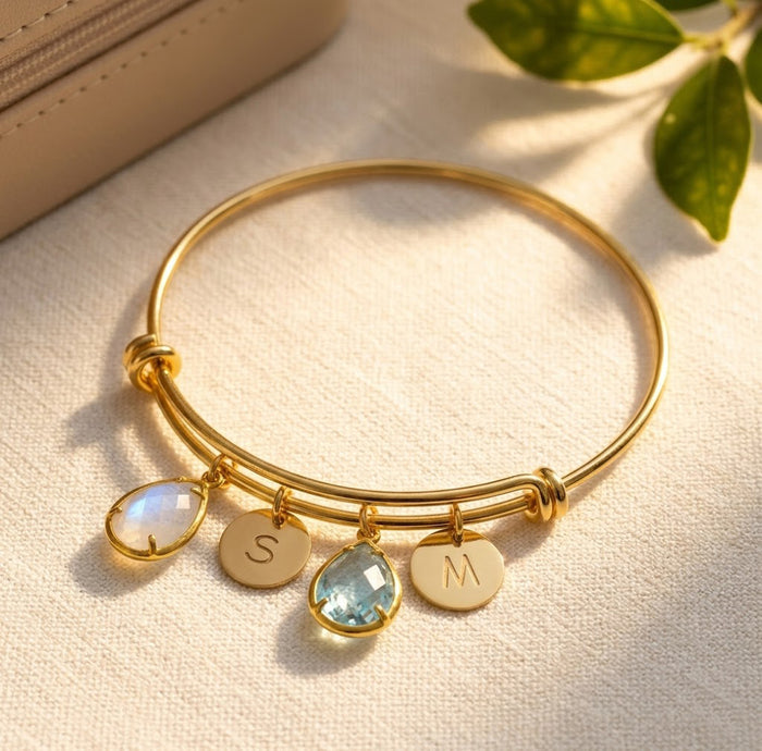 Custom birthstone bangle bracelet with teardrop birthstone charms and initial discs, personalized family bracelet for mom or grandma.