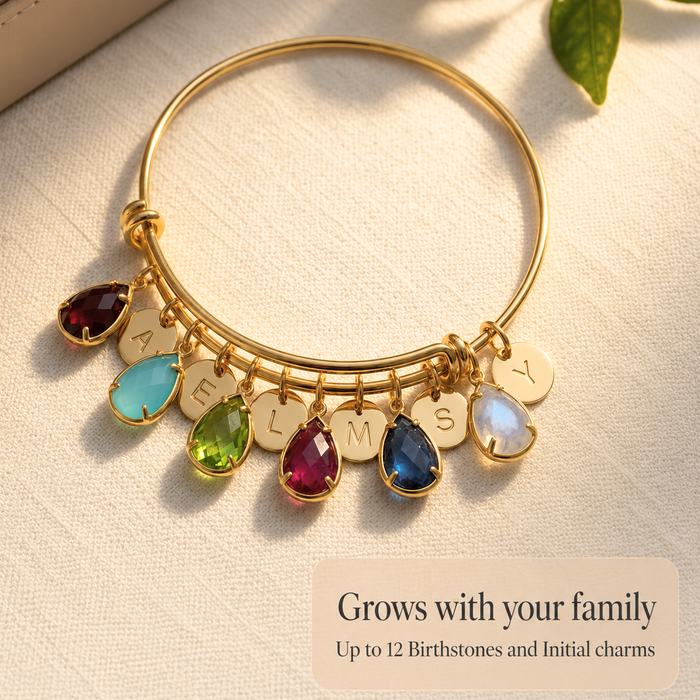 Gold custom birthstone bangle bracelet with initial charms and colorful teardrop birthstones, designed to grow with your family.