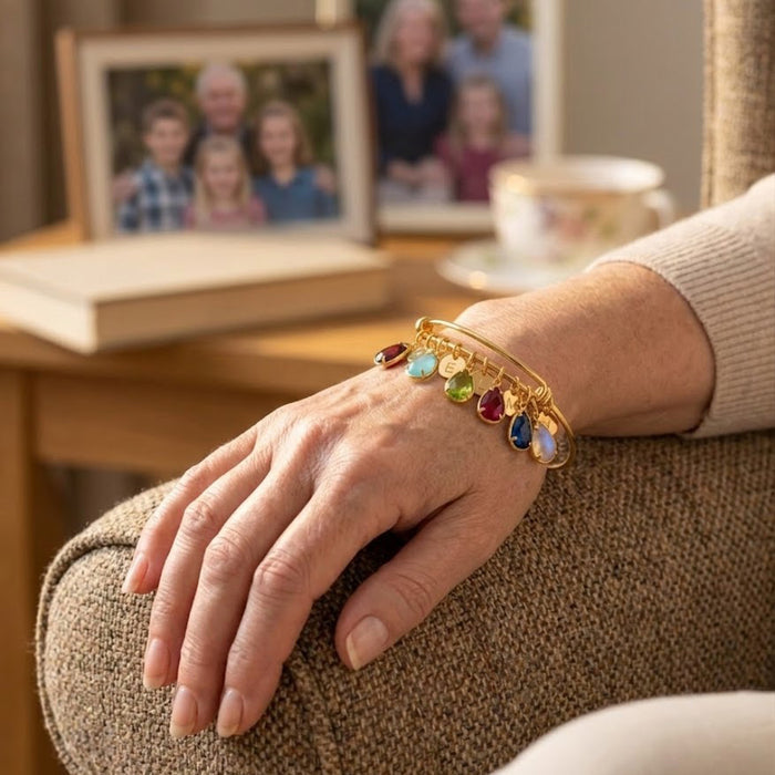 Personalized family birthstone bangle bracelet worn on wrist, custom charm bracelet for children or grandkids.