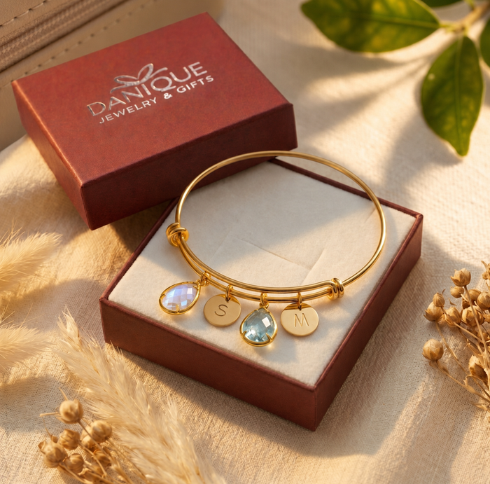 Gift-ready custom birthstone bangle bracelet displayed in Danique Jewelry box with personalized charms.
