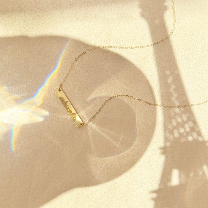 Minimalist gold Paris skyline bar necklace with artistic Eiffel tower city shadow, engraved travel jewelry for wanderlust and long distance gifts.
