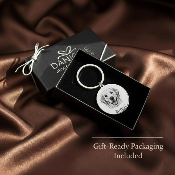 Custom engraved pet portrait keychain displayed in Danique Jewelry gift box on satin fabric, featuring a detailed engraved dog portrait and pet name. Personalized pet keychain crafted from durable metal and presented in gift-ready packaging. Meaningful pet keepsake keychain perfect for dog lovers, memorial pet gifts, birthdays, holidays, or sentimental remembrance gifts for pet parents.