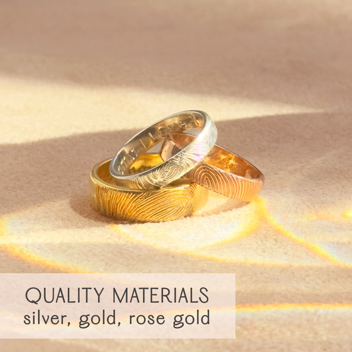 Three fingerprint engraved rings in sterling silver, yellow gold, and rose gold shown together, highlighting premium quality materials and craftsmanship. Unique custom bands designed as unisex fingerprint wedding rings, promise rings, or memorial keepsakes for couples and families. Each ring is engraved with detailed fingerprint impressions, creating meaningful personalized jewelry that honors love, memory, and connection. Perfect anniversary, sympathy, or engagement gift.
