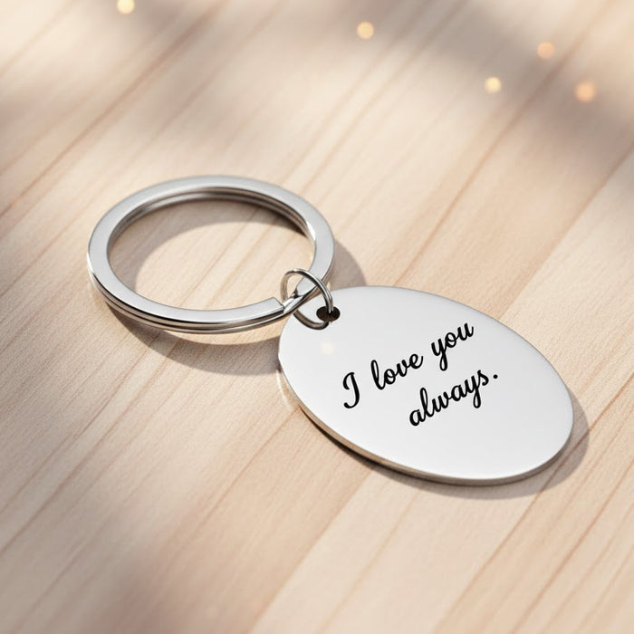 Personalized handwritten message keychain featuring a custom engraved oval tag in polished stainless steel, showcasing the phrase “I love you always” in engraved script. Includes sturdy split key ring, optional single or double-sided engraving, and supports signatures, handwriting, monograms, fingerprints, kids’ drawings, or memorial messages. Perfect personalized gift for Father’s Day, Mother’s Day, anniversaries, birthdays, or memorial keepsakes.