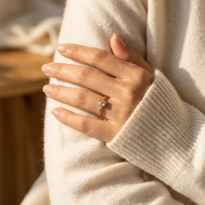 woman wearing clear quartz ring gold april birthstone jewelry