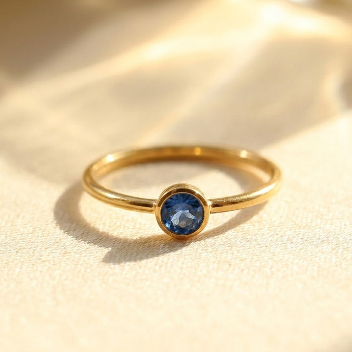Close-up of sapphire blue kyanite ring in gold vermeil, dainty bezel set September birthstone ring