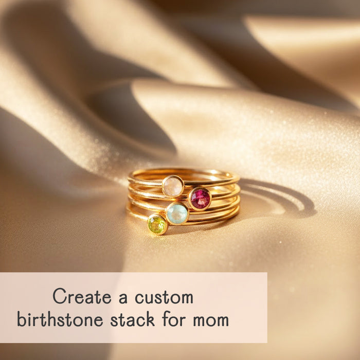 Stacked birthstone rings including June moonstone, July Ruby, March Aquamarine, August Peridot custom family stacking ring set