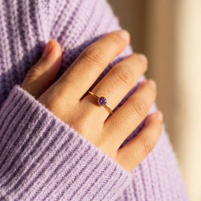 Purple amethyst stacking ring worn on hand, delicate gold birthstone ring everyday jewelry