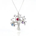 Single silver swirly tree necklace with hand stamped leaf charms and kyanite, dyed ruby and purple amethyst birthstones.