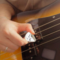 Musician playing bass guitar using custom engraved guitar pick, showing personalization in action and highlighting this as a practical and sentimental gift for music lovers.