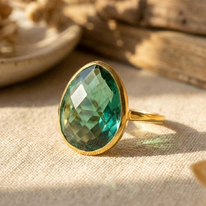 Oval green tourmaline ring in 14k gold displayed in warm natural light, October birthstone jewelry gift for her, elegant minimalist gemstone ring