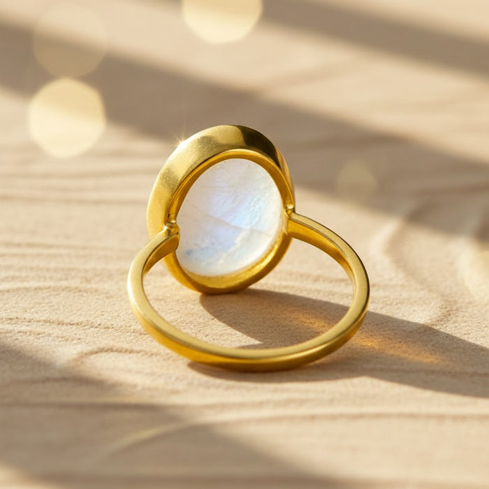 Gold vermeil rainbow moonstone oval ring shown from a side angle, highlighting the smooth bezel setting and elegant band design. June birthstone ring with a glowing oval moonstone, crafted in a minimalist silhouette ideal for stacking or wearing alone. Handmade moonstone jewelry perfect for birthdays, anniversaries, Valentine’s Day, or everyday elegance.