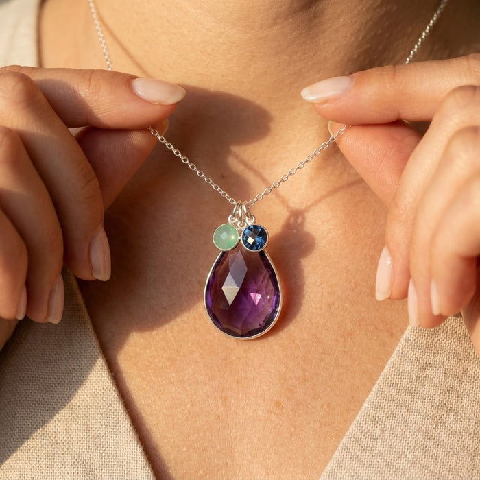 Mom birthstone necklace worn on model with large gemstone and small children birthstone charms