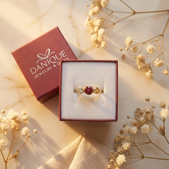 Custom mom ring with center stone and two side birthstones, symbolic family jewelry
