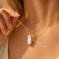 Personalized moonstone bar necklace worn on a model with a hidden side engraving and secret message text, shown as a June birthstone gift.