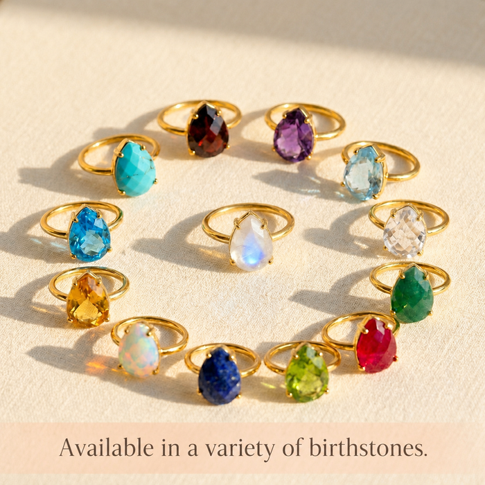 Collection of teardrop birthstone rings in colorful gemstone options, showing opalite and other birthstone rings available in a variety of stones.