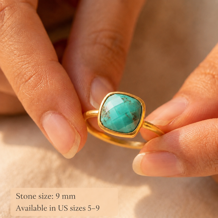 Close-up of natural turquoise cushion ring held between fingers with stone size note.