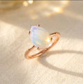 Opalite teardrop prong ring in rose gold vermeil, an October birthstone ring with a soft iridescent pear gemstone for a birthday gift or stacking ring.