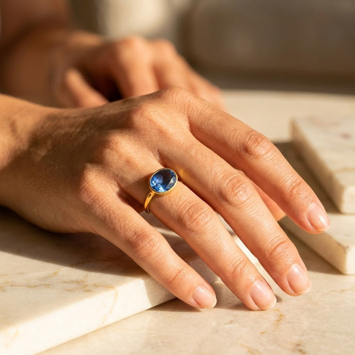 Blue kyanite ring cushion cut gemstone in gold bezel setting