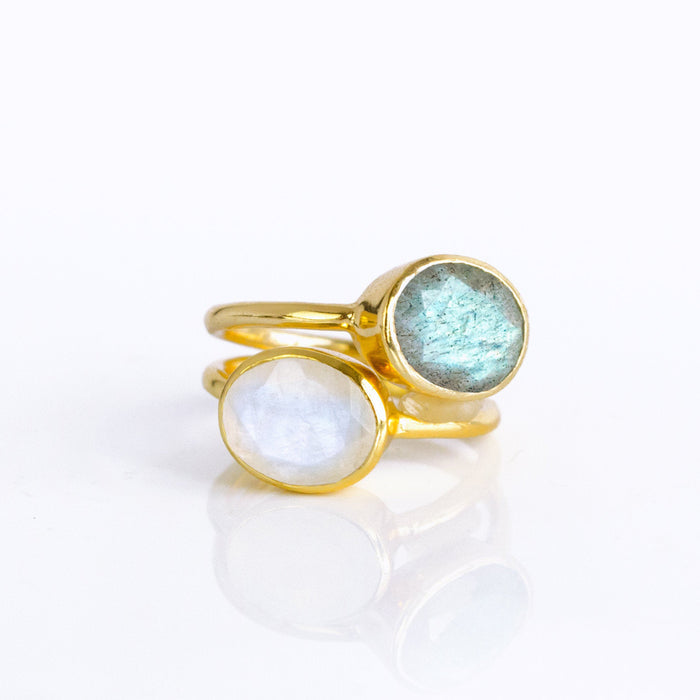 Twin gemstone rings in a round bezel duo—labradorite with blue-green flash stacked with a luminous rainbow moonstone—set in sleek gold-plated bands. Artisan-crafted boho stacking set for everyday style or bridal-party gifts; round cabochon look, slim profiles, and comfortable fit make this gem duo a chic wardrobe staple and a thoughtful jewelry present for her.