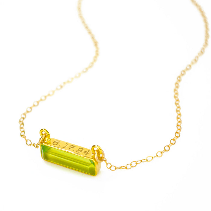 Gold filled cable chain horizontal adira bar peridot august birthstone necklace with secret message engraved on top in typewriter font.