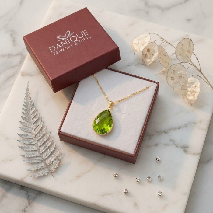 Peridot necklace displayed in a Danique Jewelry branded gift box with soft natural styling.