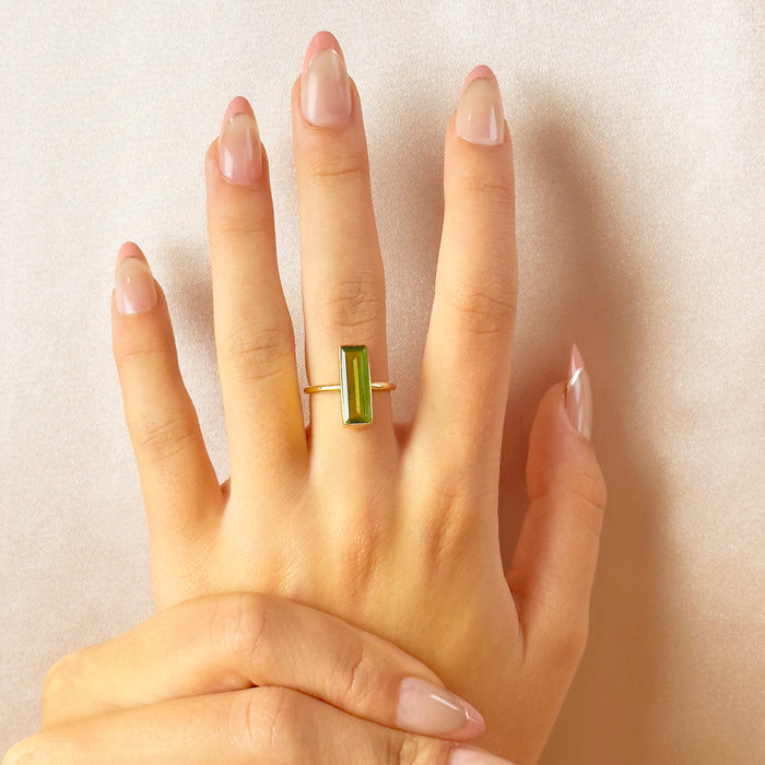 Model wearing the petite green Peridot Quartz baguette ring on her middle finger