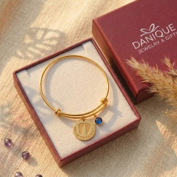 Gift-ready personalized baby footprint bracelet in Danique Jewelry box, a custom new mom gift for baby shower or Mother’s Day.