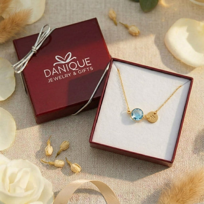 Personalized blue topaz necklace in Danique Jewelry gift box.