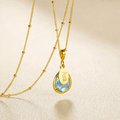 Gold blue topaz name necklace with sky blue teardrop pendant and engraved oval charm
