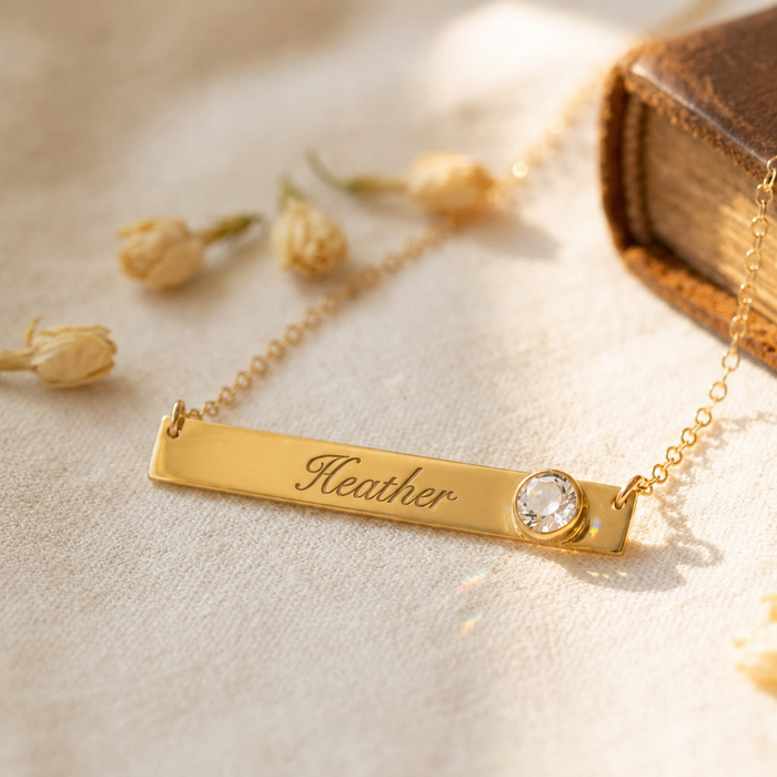 April birthstone name bar necklace in yellow gold vermeil with clear quartz accent
