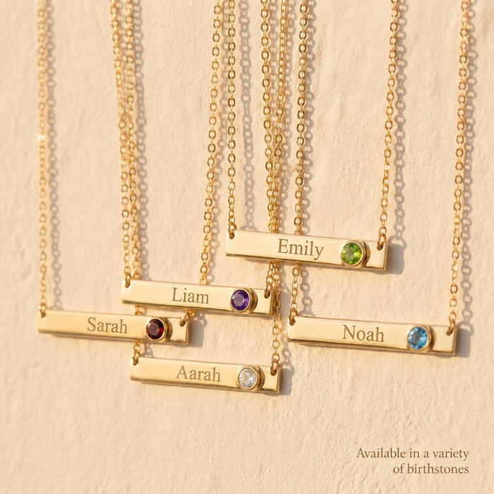 Gold engraved birthstone bar necklaces shown with different names and birthstone colors.