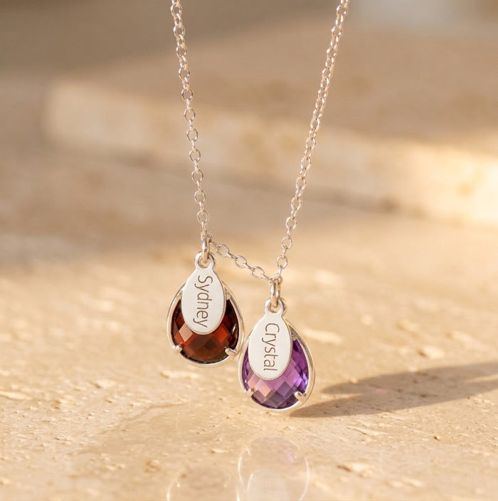 Sterling silver family necklace with engraved name tags and colorful teardrop birthstones