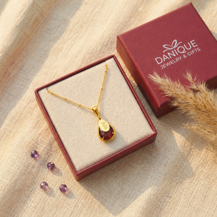 Deep red garnet teardrop necklace displayed in Danique jewelry gift box.